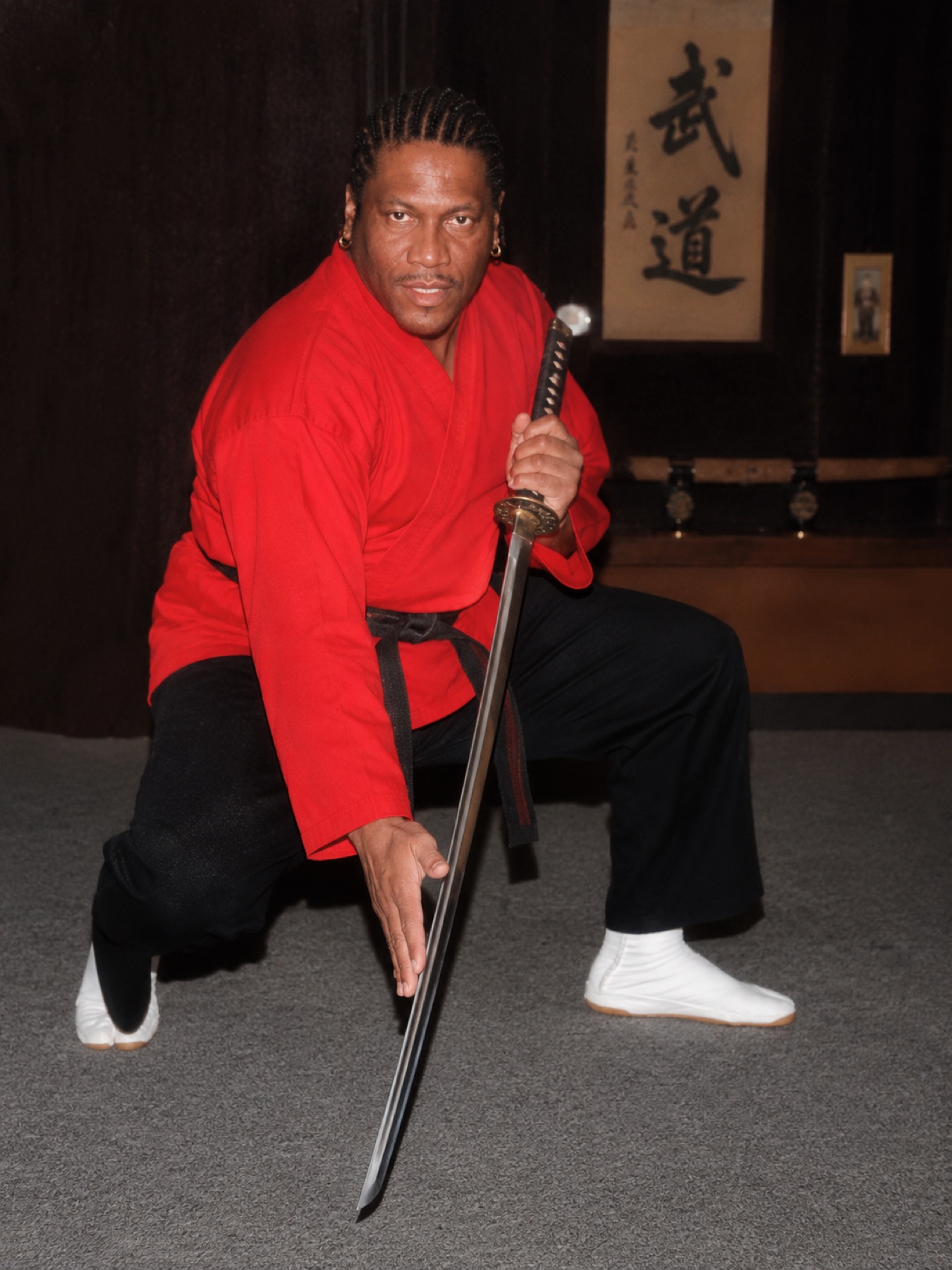 Professor Kenneth Worthy holding a sword in a legacy portrait