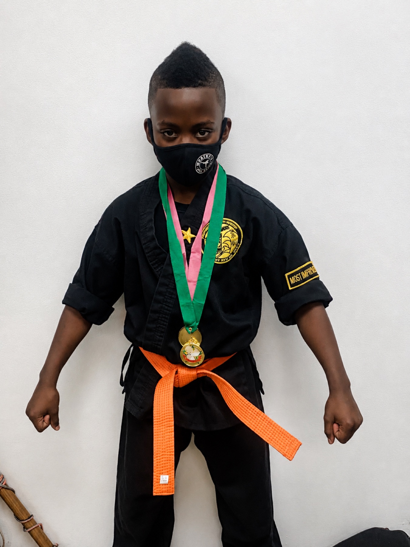 Youth Worthy Ryu student in uniform with a medal