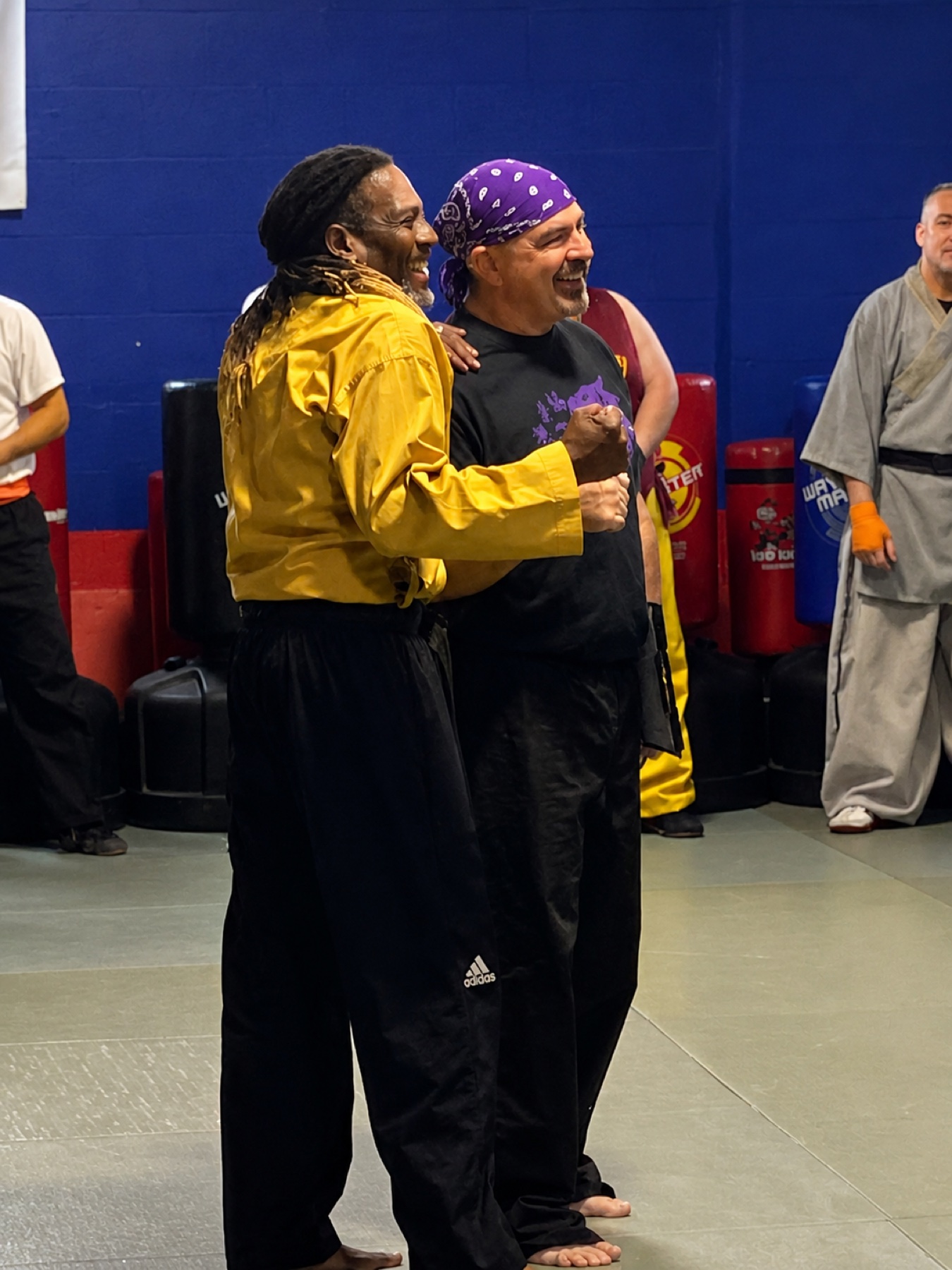 Professor Kenneth Worthy celebrating with another martial arts instructor