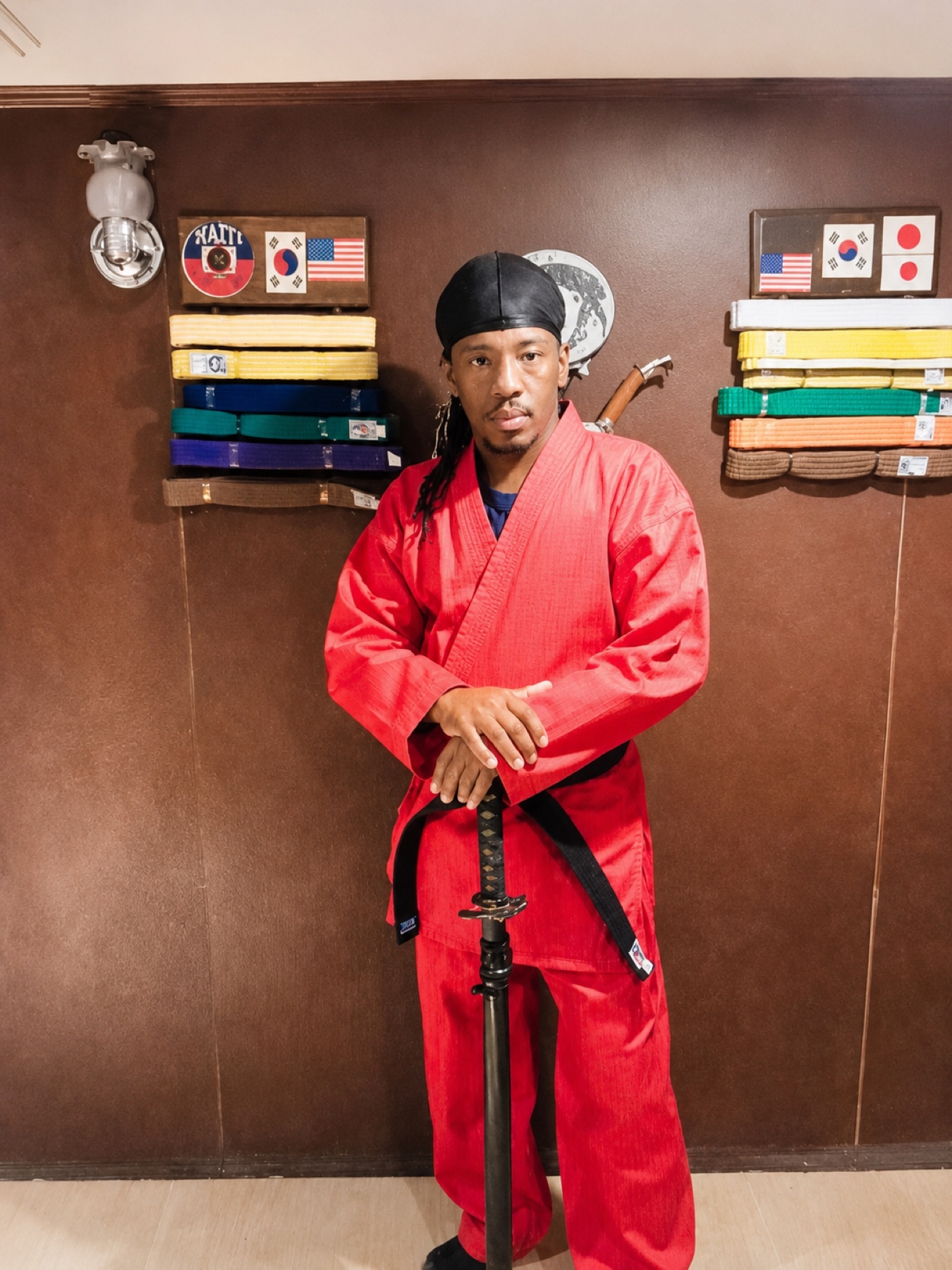Worthy Ryu instructor in a red uniform holding a sword
