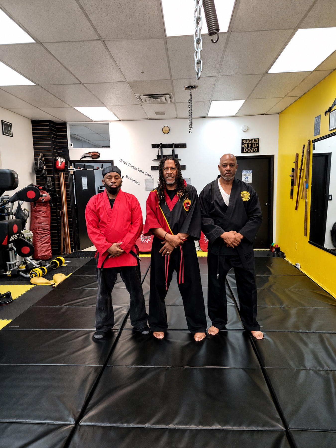 Three Worthy Ryu instructors standing in the dojo