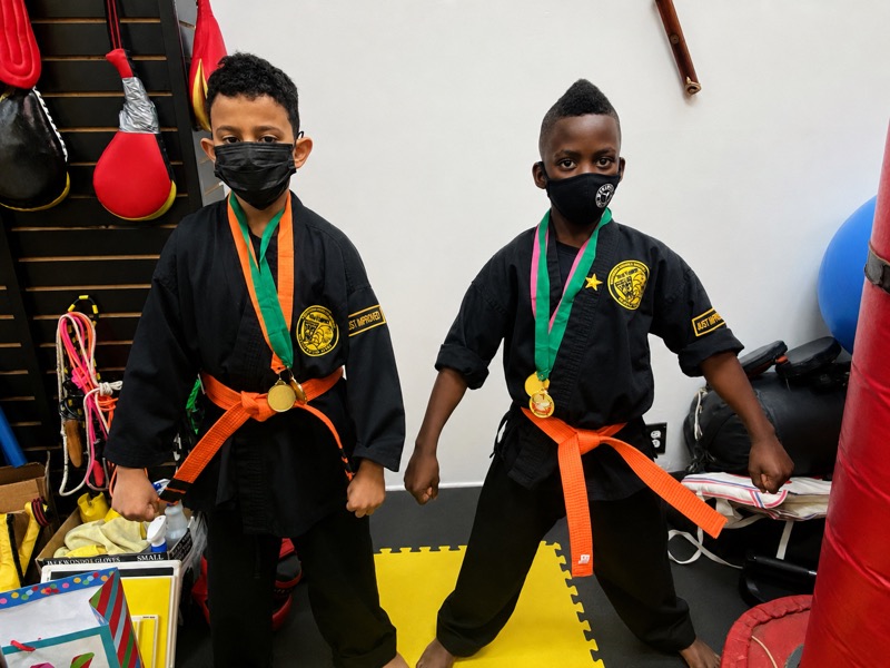 Two youth Worthy Ryu students in uniform with medals